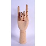 A CONTEMPORARY CARVED WOOD ARTICULATED LAY TYPE RING DISPLAY in the form of a hand. 30 cm high exten
