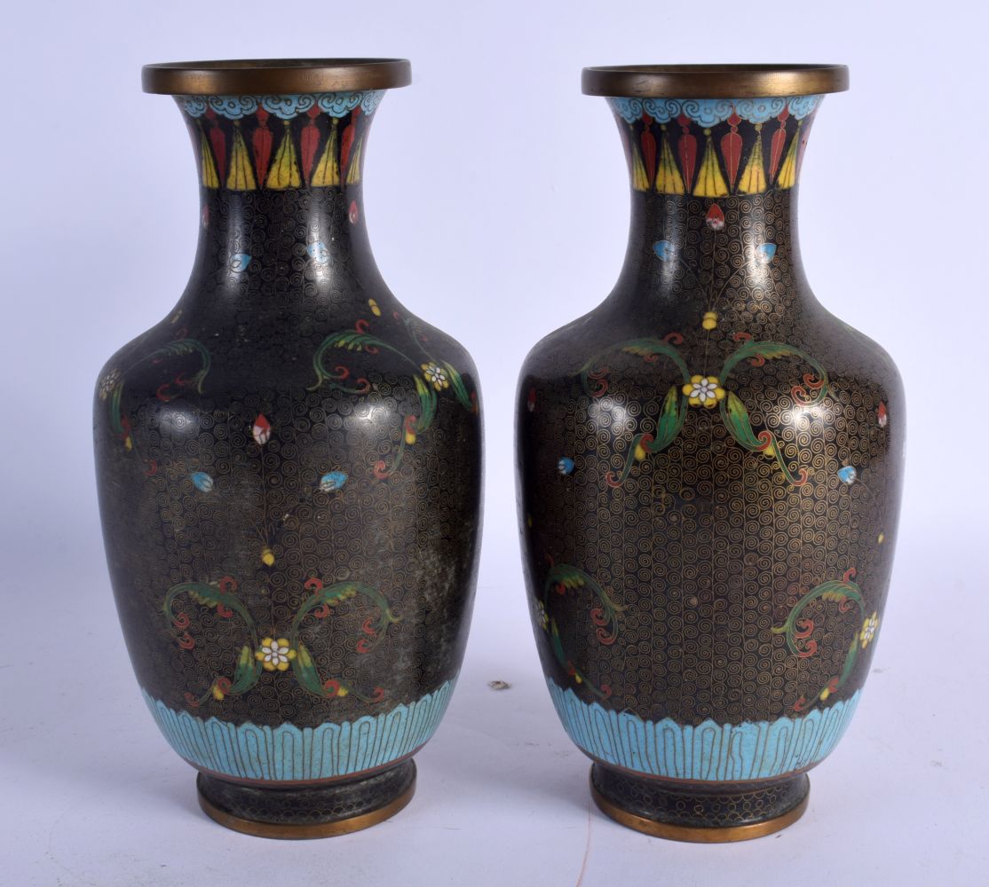 A PAIR OF EARLY 20TH CENTURY CHINESE CLOISONNE ENAMEL VASES decorated with foliage. 26.5 cm high.