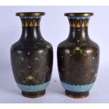 A PAIR OF EARLY 20TH CENTURY CHINESE CLOISONNE ENAMEL VASES decorated with foliage. 26.5 cm high.