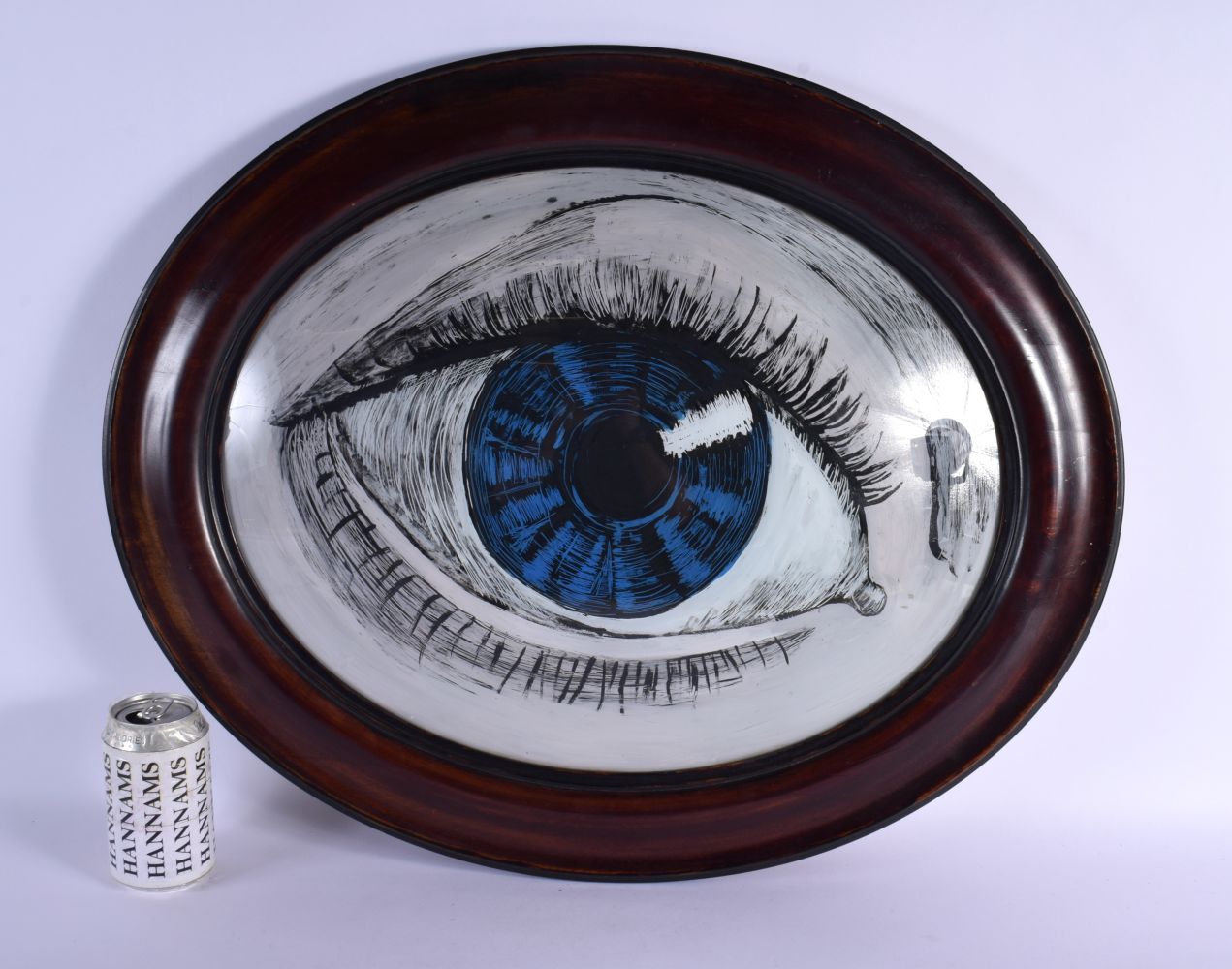 A VINTAGE REVERSE PAINTED GLASS PANEL OF AN EYE. 62 cm x 52 cm.