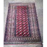 A Persian red ground rug 194 x 124 cm .