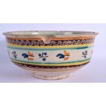 A 17TH/18TH CENTURY SOUTH EUROPEAN FAIENCE GLAZED BOWL painted with sparse foliage. 24 cm x 12 cm.