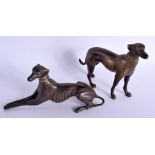 A PAIR OF ANTIQUE BRONZE GREYHOUNDS one modelled recumbent. Largest 12 cm x 14 cm.
