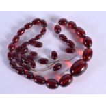 A CHERRY AMBER TYPE NECKLACE. 62cm long, weight 54g