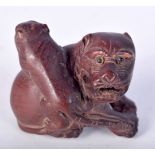 A JAPANESE WOOD NETSUKE CARVED AS A BEAST WITH YOUNG ON ITS BACK. 3.4cm x 4.1cm x 2.8cm, weight 15.