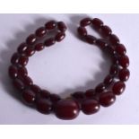 CHERRY AMBER NECKLACE. 62cm long, Largest bead 27.7mm 22.3mm, weight 63.8g