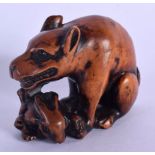 A 19TH CENTURY JAPANESE MEIJI PERIOD CARVED BOXWOOD NETSUKE modelled as a wolf clutching a rabbit. 4