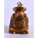 A GOLD MOUNTED AMBER PENDANT OF A SEATED FIGURE. 3.2cm x 1.8cm, weight 8g