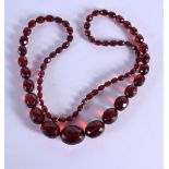 A CHERRY AMBER TYPE NECKLACE. 90cm long, weight 86g