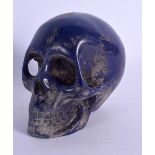 A CONTINENTAL CARVED LAPIS LAZULI SKULL. 14 cm x 8 cm.