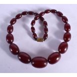 CHERRY AMBER NECKLACE. Length 43cm, largest bead 19mm, weight 45g