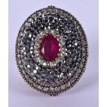 A VINTAGE INDIAN SILVER GOLD AND RUBY RING. 24 grams.