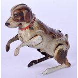 A VINTAGE GERMAN TIN PLATE BEGGING DOG. 8 cm x 4 cm.