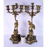 A LARGE PAIR OF 19TH CENTURY FRENCH BRONZE CANDLEABRA formed with figures upon rococo bases. 55 cm x