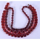 TWO CHERRY AMBER BAKELITE NECKLACES one of graduated form. Graduated necklace 49 grams, 58 cm long &