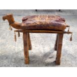 A VINTAGE LEATHER AND CARVED WOOD CAMEL STOOL. 42 cm x 57 cm x 25 cm.