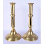 A PAIR OF ANTIQUE BRASS CANDLESTICKS. 28 cm high.