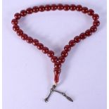A TURKISH MIDDLE EASTERN RED AMBER CATALIN TYPE PRAYER BEAD NECKLACE. 51 grams. 40 cm long.