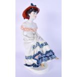 A MEISSEN PORCELAIN FIGURE OF A SEATED FEMALE modelled wearing a dress. 24 cm high.