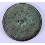 AN EARLY CHINESE BRONZE HAND MIRROR of tiny proportions 5.5 cm diameter.