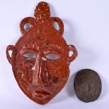 AN EARLY 20TH CENTURY EUROPEAN BRONZE PORTRAIT PLAQUE together with a studio pottery mask. Largest 2