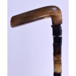 A 19TH CENTURY MIDDLE EASTERN CARVED RHINOCEROS HORN HANDLED WALKING CANE with horn shaft. 90 cm lon