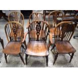 A SET OF SIX COUNTRY WHEEL BACK ELM AND BEECH DINING CHAIRS. 90 cm x 49 cm x 42 cm. (6)