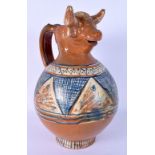 AN ITALIAN PAINTED TERRACOTTA JUG with bull head spout. 30 cm x 14 cm.