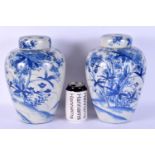 A LARGE PAIR OF 19TH CENTURY JAPANESE MEIJI PERIOD BLUE AND WHITE VASES AND COVERS painted with land