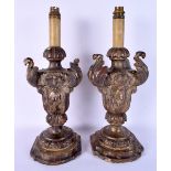 A PAIR OF 17TH/18TH CENTURY SOUTHERN EUROPEAN WOOD CANDLESTICKS converted to lamps. 43 cm high overa
