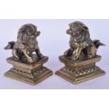 A PAIR OF 19TH CENTURY CHINESE BRONZE FIGURES OF BUDDHISTIC LIONS modelled upon square bases. 9 cm x