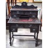 AN ANTIQUE CONTINENTAL OAK DESK decorated with mask heads. 122 cm x 85 cm x 50 cm.