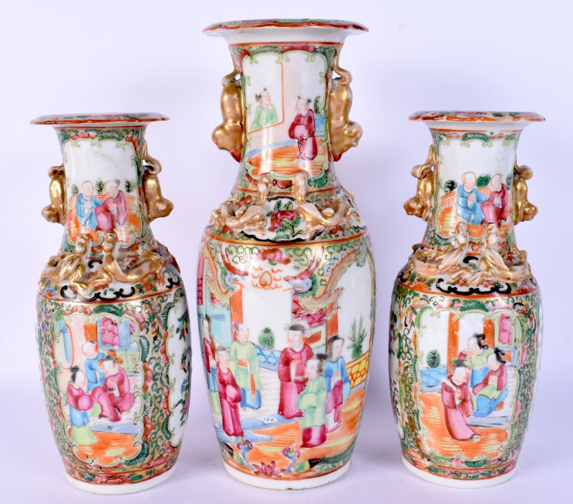 A SET OF THREE 19TH CENTURY CHINESE CANTON FAMILLE ROSE VASES Qing. Largest 28 cm high. (3)