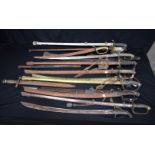 A LARGE COLLECTION OF ANTIQUE SWORDS together with Persian daggers etc, contained within a brass pot