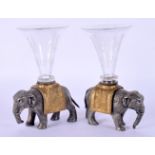 A RARE PAIR OF 19TH CENTURY FRANCO JAPANESE SPILL VASES formed as standing elephants. 15 cm x 9 cm.