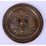 AN EARLY CHINESE BRONZE HAND MIRROR decorated with mythical beasts in various pursuits. 12 cm diamet