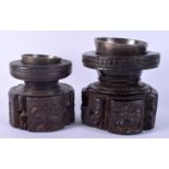 A RARE NEAR PAIR OF 17TH/18TH CENTURY INDIAN CARVED WOOD MORTARS carved with Buddhistic figures. Lar