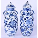 A PAIR OF 19TH CENTURY CHINESE TWIN HANDLED BLUE AND WHITE VASES AND COVERS painted with moths and f