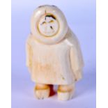 A RARE EARLY 20TH NORTH AMERICAN CARVED IVORY FIGURE OF AN ESKIMO possibly tribal. 7 cm x 4 cm.