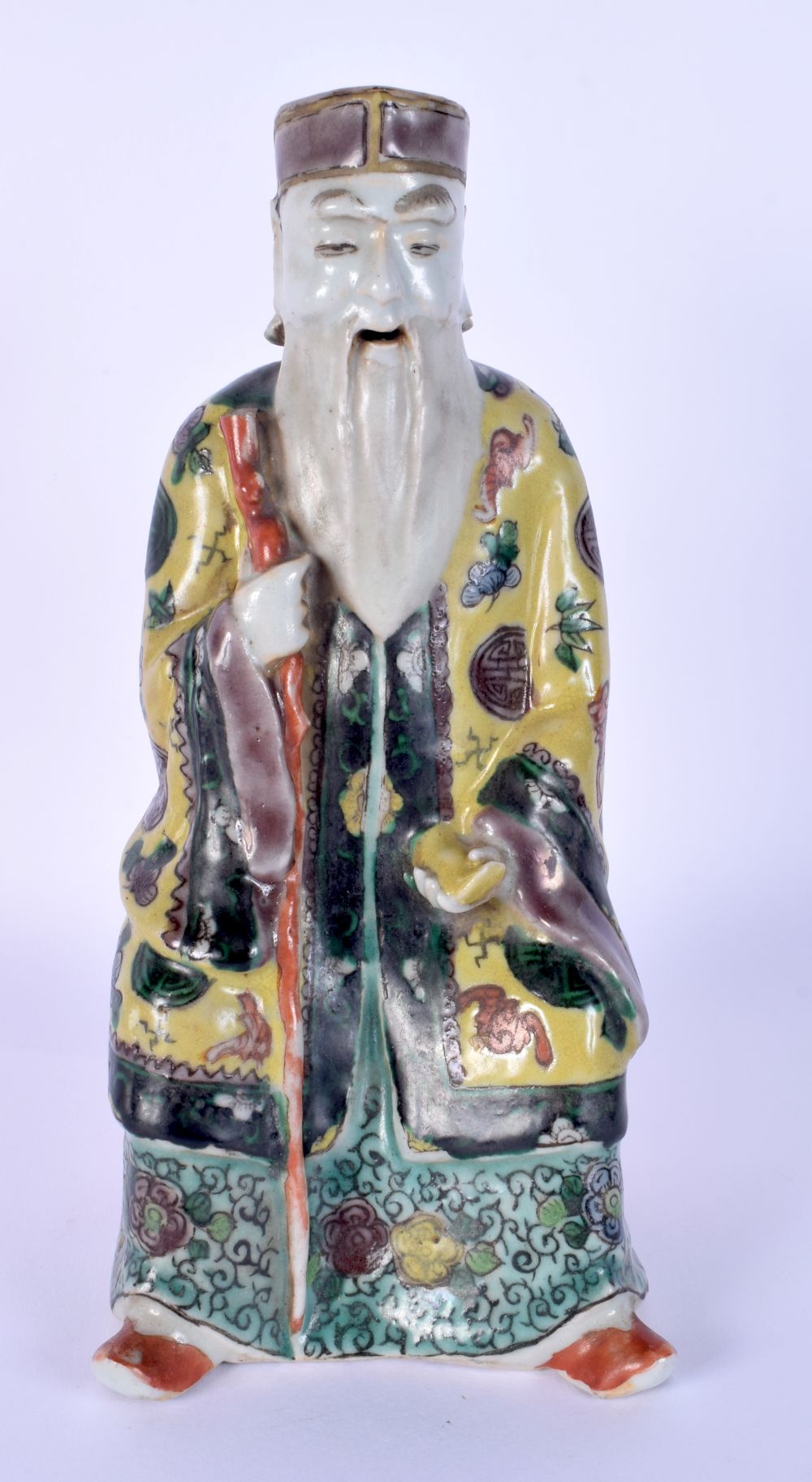 A 19TH CENTURY CHINESE FAMILLE JAUNE PORCELAIN FIGURE OF AN IMMORTAL Qing. 21 cm high.