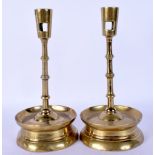 A PAIR OF ANTIQUE BRASS CANDLESTICKS. 24 cm high.