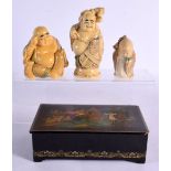 A RUSSIAN BLACK LACQUER BOX and three ivorine buddhas. Largest 20 cm x 12 cm. (4)