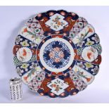 A LARGE 19TH CENTURY JAPANESE MEIJI PERIOD IMARI FLUTED PORCELAIN DISH painted with flowers. 45 cm w