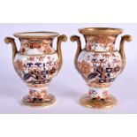 A PAIR OF EARLY 19TH CENTURY SPODE TWIN HANDLED PORCELAIN VASES painted with imari landscapes. 10 cm