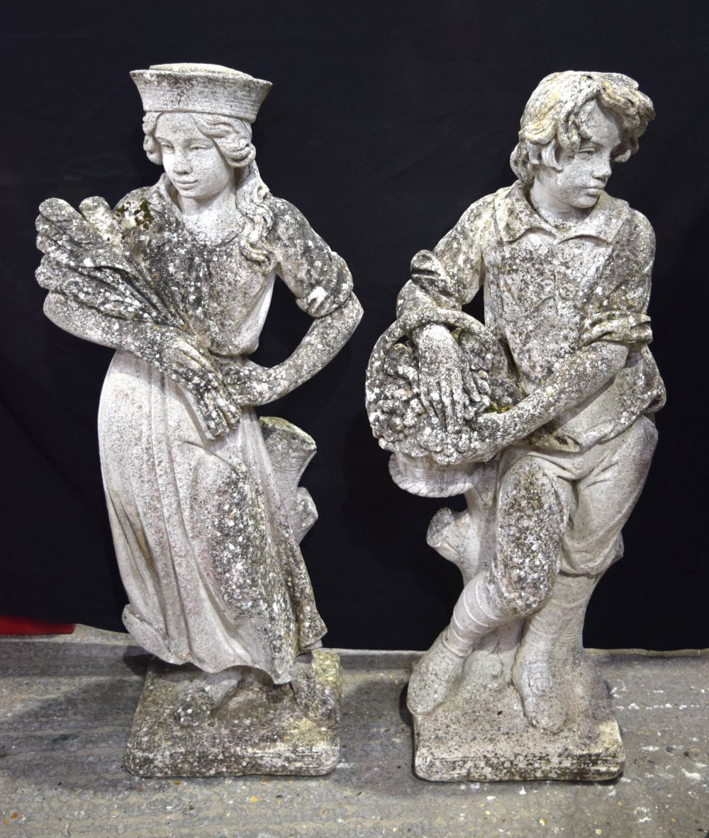 A pair of large stone statues of a boy and a girl fruit pickers from the gardens of The Burrows pri