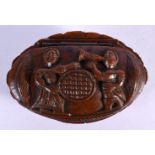 AN 18TH/19TH CENTURY CONTINENTAL CARVED COQUILLA NUT SNUFF BOX decorated with figures. 7 cm x 4.5 cm