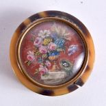 A TORTOISESHELL BOX AND COVER WITH A FLORAL INSET. 5cm x 1.5cm