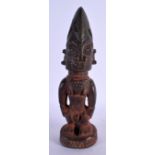 AN AFRICAN TRIBAL CARVED WOOD FIGURE. 27 cm high.