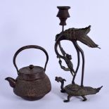A 19TH CENTURY JAPANESE MEIJI PERIOD IRON TEAPOT AND COVER and a Japanese bronze candlestick. Larges