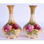 Royal Worcester pair of vases painted with roses shape G702 date mark 1924. 14cm high.